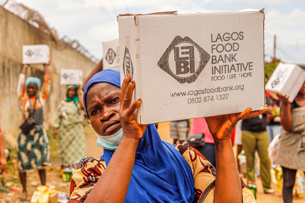 services-03 Community members engage in food distribution at Lagos Food Bank initiative event.
